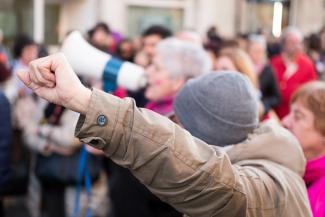 White person with raised fist protesting.